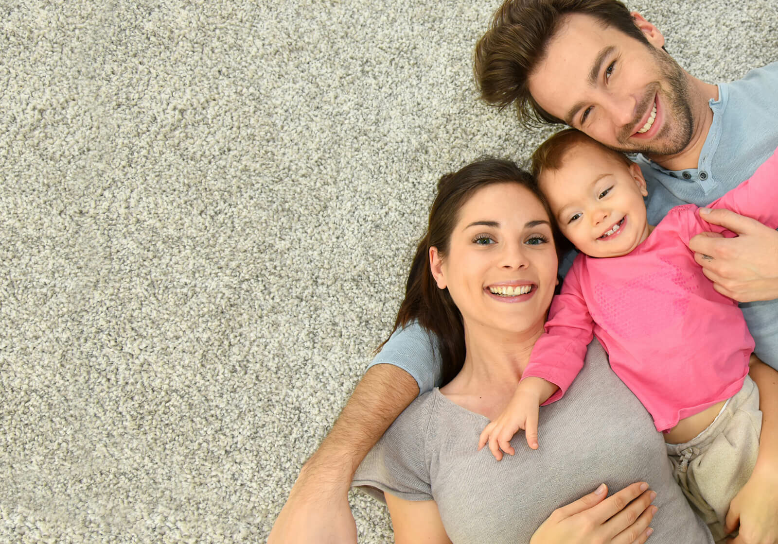 Happy family laying on Carpet | Bereman Carpets Inc